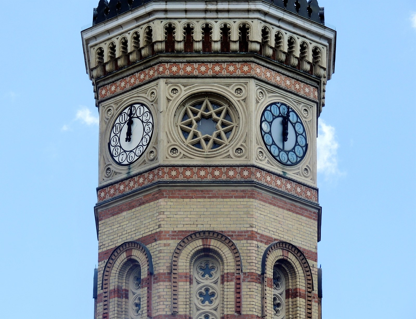 Ornate clock tower against blue sky